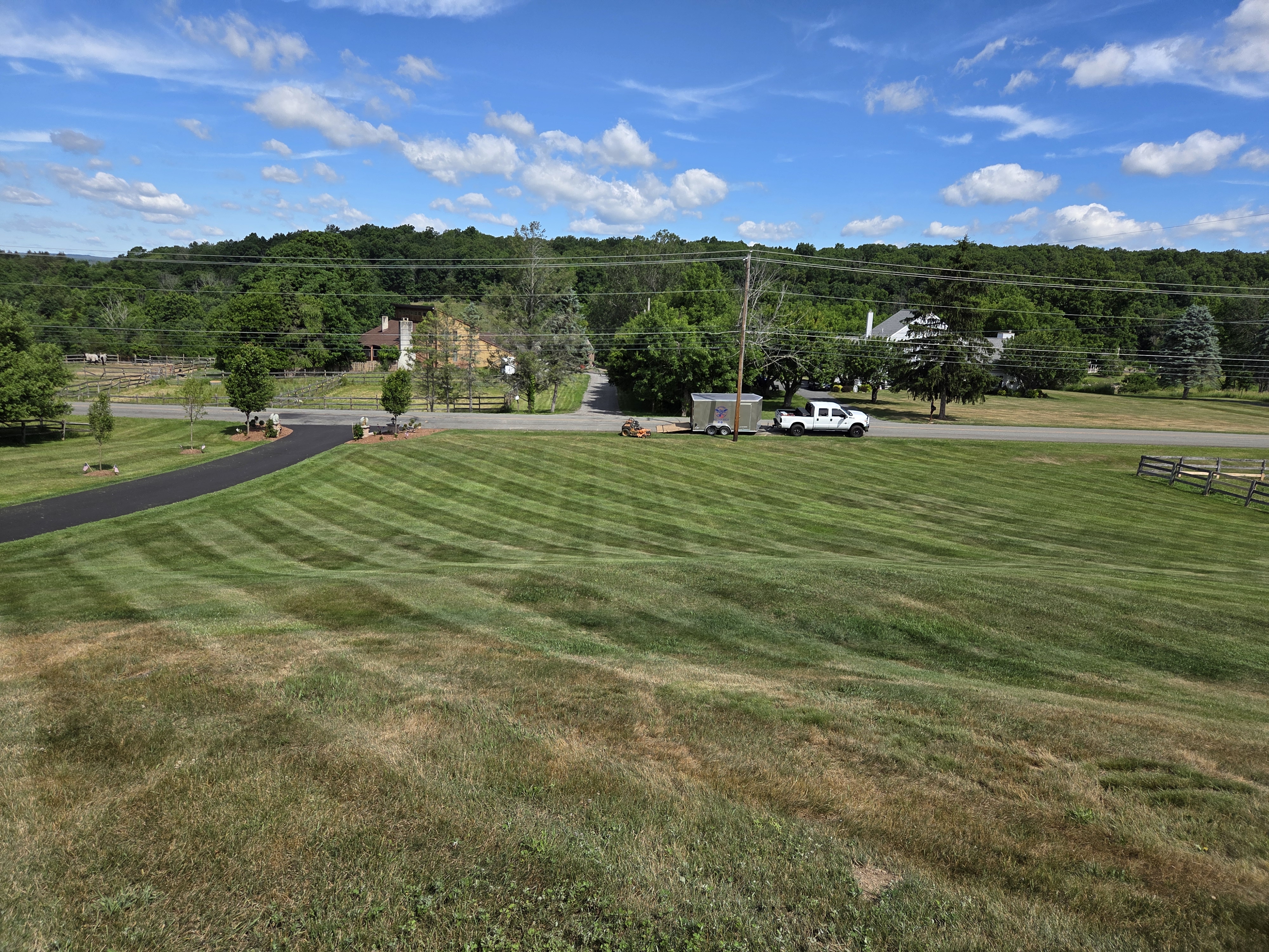 CP Clark truck, trailer and mower on a freshly striped healthy lawn grown from seed in Sussex County, New Jersey